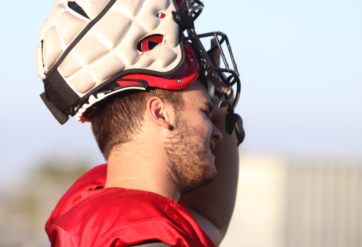 Brent takes off his helmet. 